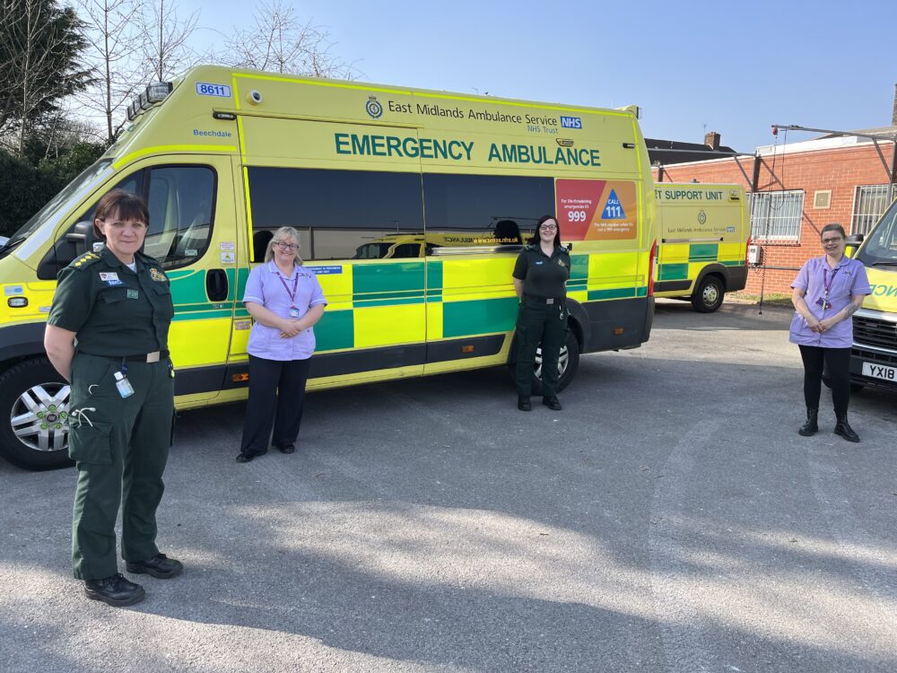 Hospice staff with EMAS crew members and an ambulance