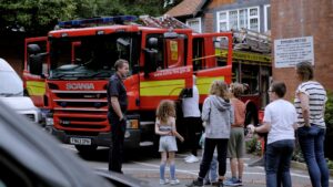 Children with fire engine at hospice summer fair