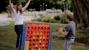 People playing giant Connect 4 at hospice summer fair